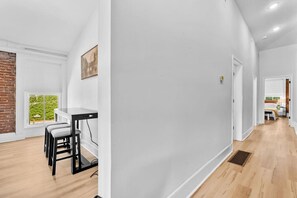 A modern interior with a dining area, a kitchen, and a bedroom. - Hot Tub | 6BR-4BA | Sleep 12+ | Game Rm | Fire Pit (Louisville)