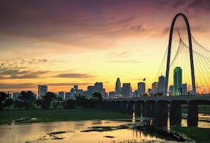 A city skyline with a prominent cable-stayed bridge and a river in the foreground. - Cozy Bungalow-Dallas Central (Dallas)
