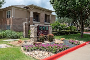 A building with a sign reading 'RANCH at Hudson Xing Premier Apartments.' - Landing Stunning 1bd, Gym (McKinney)