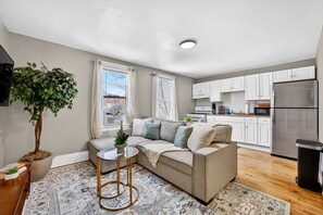 Eine moderne Wohnung mit Wohnzimmer, Küche und Essbereich.