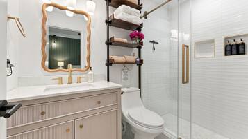 Spa elegance meets French luxury: marble, gold fixtures, and a showstopping shower where every morning feels like a getaway.