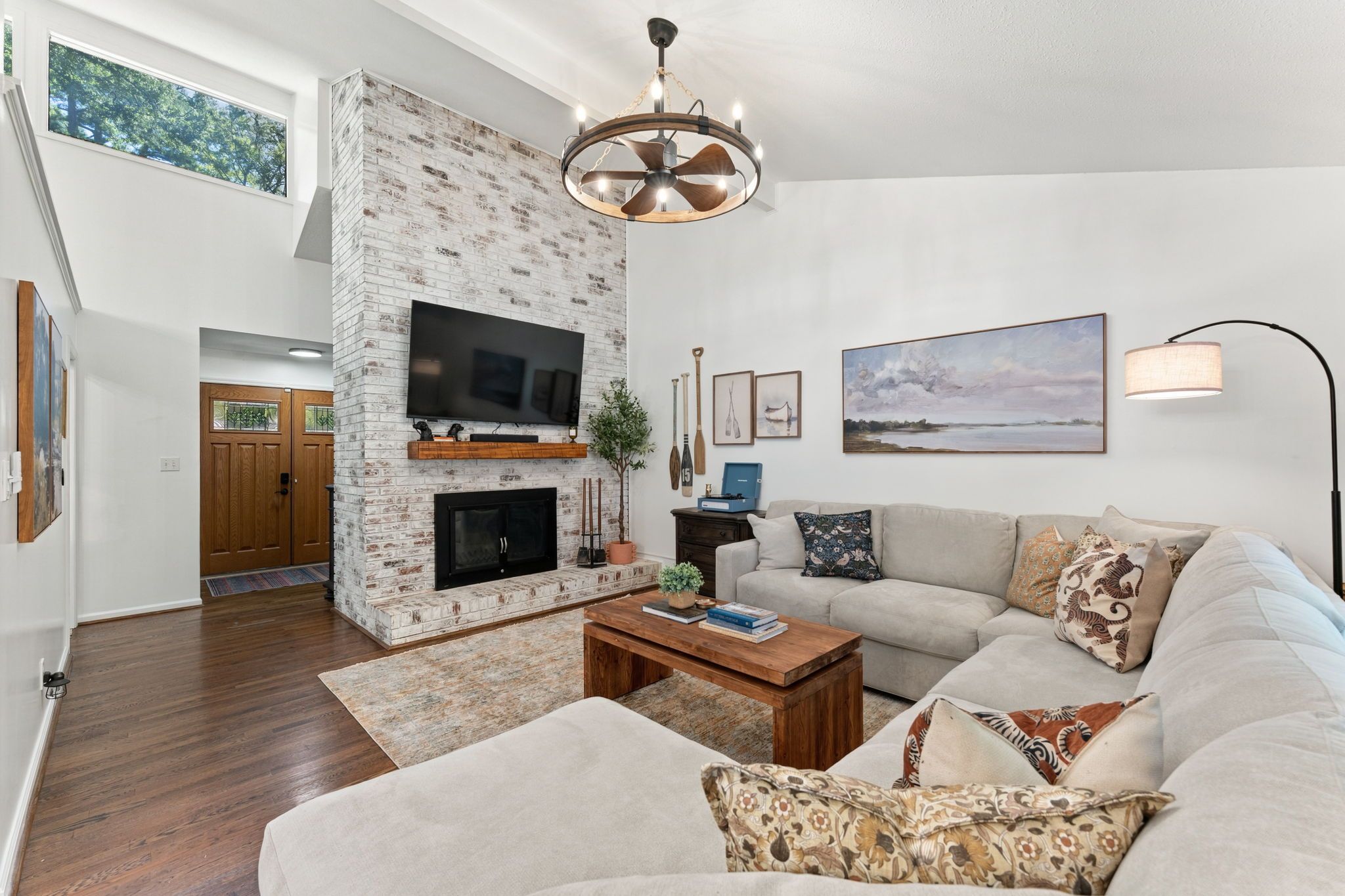Una sala de estar con chimenea, televisor de pantalla plana, sofá y mesa de centro.