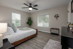 A bedroom with a bed, a ceiling fan, a plant, and a bench. - Relax In Sedona/Thunder Mountain Views (Sedona)