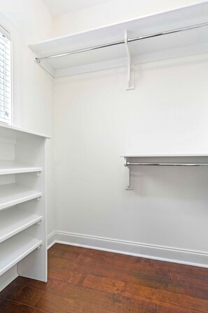 A closet with white shelving and a metal rod, wooden flooring, and a white wall. - NEW! 2 Bed/2.5 Bath - 0.7 Mi From Jordan-Hare Stadium (Auburn)