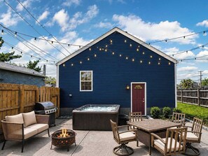 A blue building with a hot tub, outdoor seating, and a barbecue grill. - The Wild Side Retreat | Hot Tub • Walk Everywhere! (Louisville)
