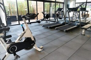 A gym with stationary bikes, treadmills, and exercise equipment. - EON Zone 10. Luxury, Views, and Comfort—All in One Apartment (Ciudad de Guatemala)