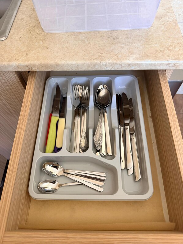 A drawer with compartments containing various utensils including forks, spoons, and knives. - Bright & Cozy Yerevan Apartment with City View Near City Center & Self Check-in (Yerevan)