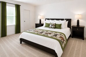 A bedroom with a bed, two bedside tables, a door, and a window with curtains. - Suncrest Residence (Kissimmee)