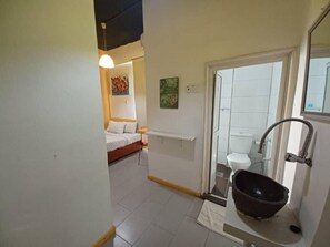 A bathroom with a sink, toilet, and shower area. - The Serai Cottage Transit Hotel (Kuala Terengganu)