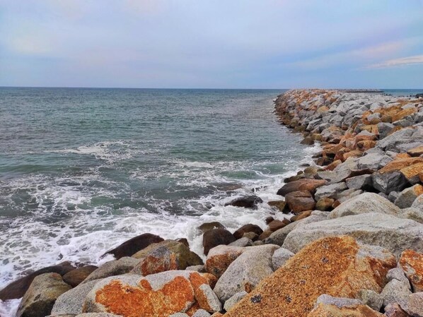 A rocky shoreline with waves crashing against the rocks. - The Serai Cottage Transit Hotel (Kuala Terengganu)