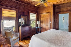 A wooden room with a bed, a dresser, a chair, and a ceiling fan. - The Ark - Add to the History and Memories of Sullivan (Sullivans Island)