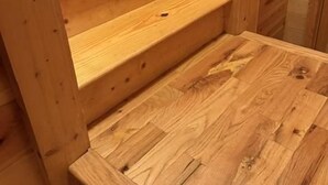A wooden staircase with multiple steps leading to a landing.