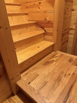A wooden staircase with multiple steps leading to a landing.