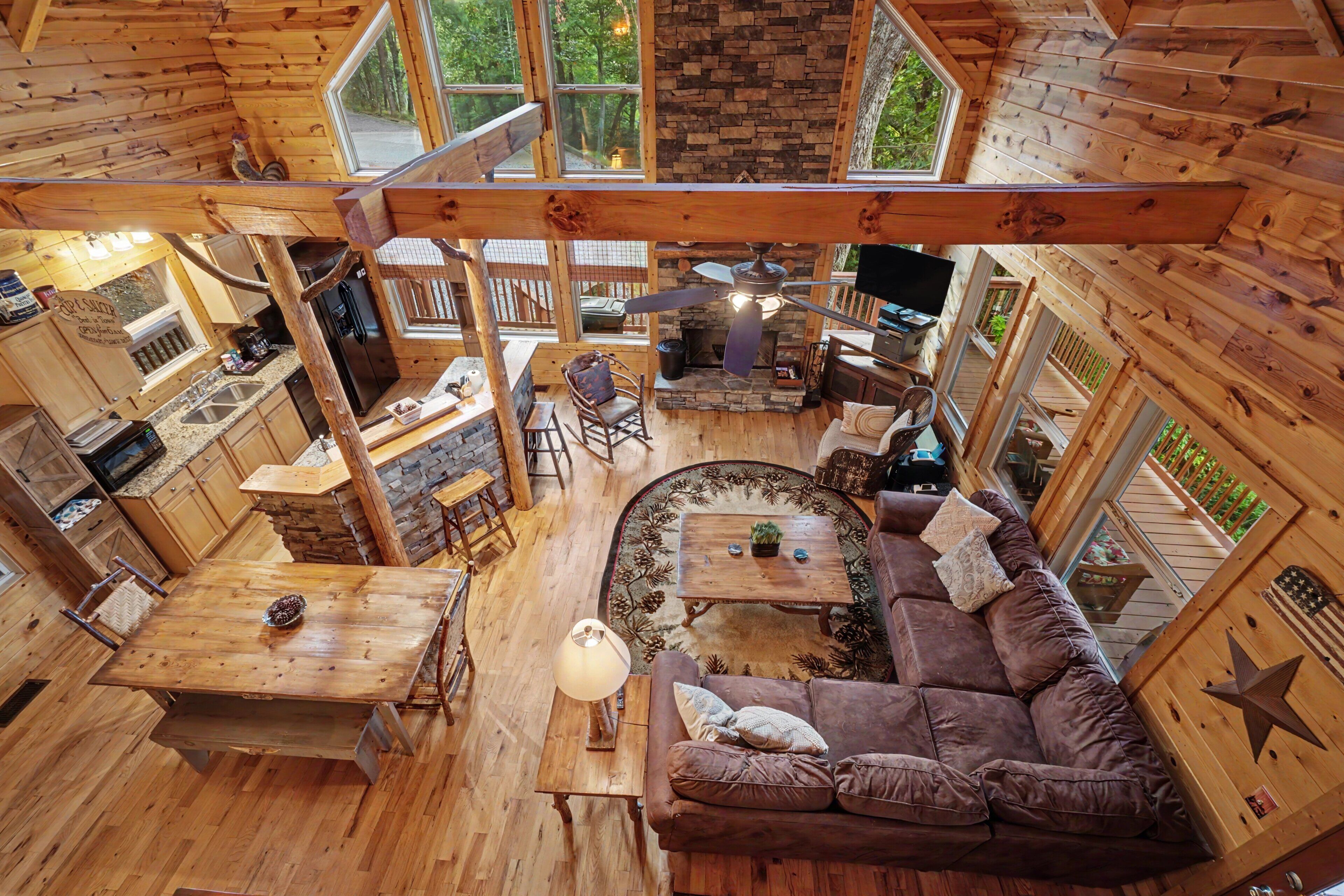 A cabin interior with a kitchen, dining area, and living room.