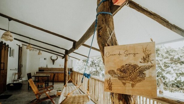 A rustic wooden structure with a hanging sign that reads 'Casa de Sonya.'