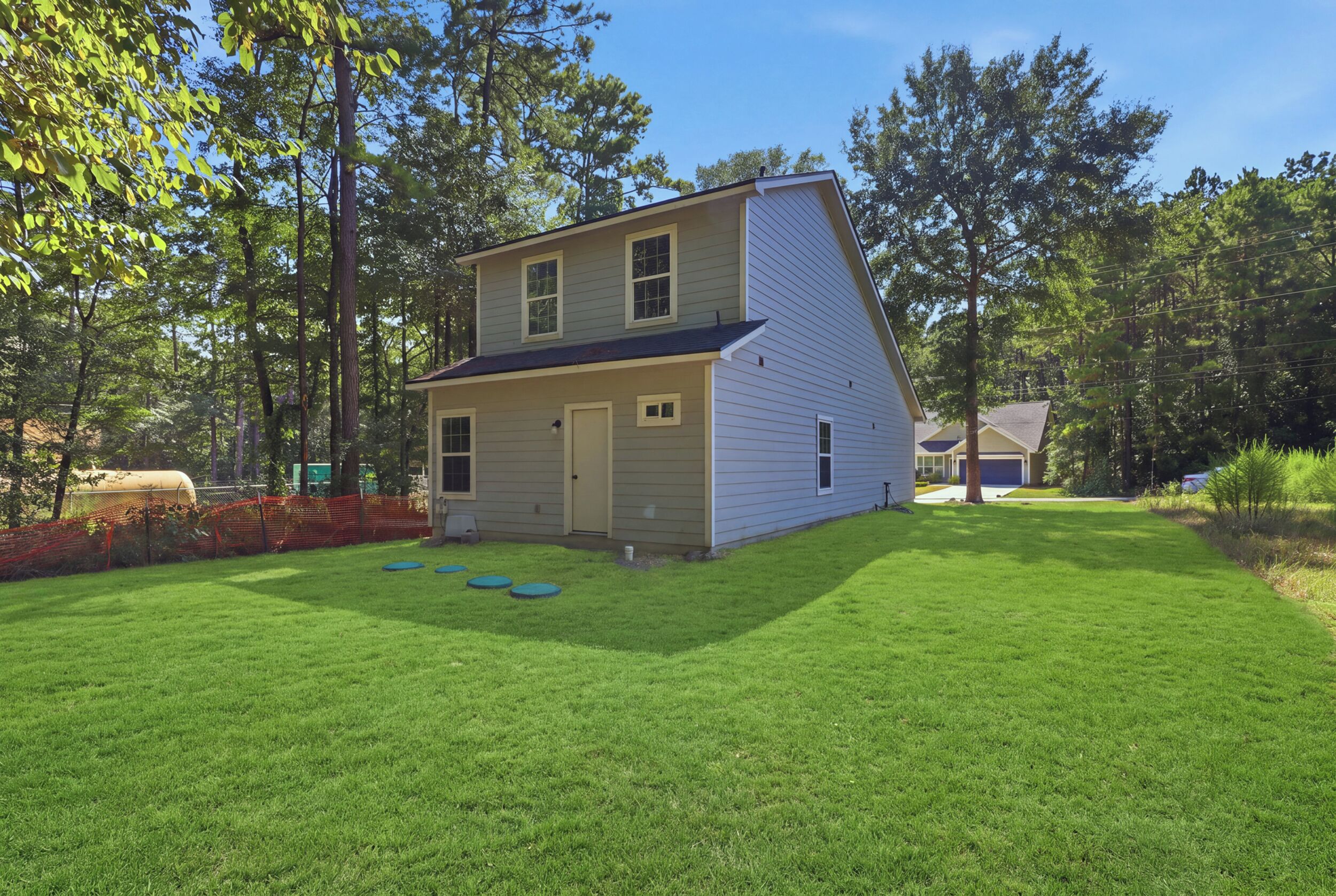 A two-story house with a front yard and a garage.