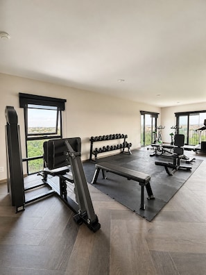A gym with exercise equipment, a bench, and dumbbells. - New Studio · Rooftop Terrace · Historic Center of GDL (guadalajara)