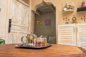 A tray with a silver teapot and glasses on a wooden table. - Refuge Oriental: 2BR Medina Home with Private Copper Hammam (Essaouira)