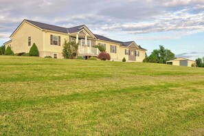 A two-story house with a front porch, a garage, and a well-maintained lawn.