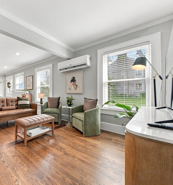 A living room with a sofa, chairs, a coffee table, and a desk with a lamp.