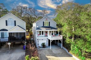 Two single-story houses with attached porches, a garage, and a small driveway. - Charming 3-Bed Beach House with bathtub and BBQ (Surfside Beach)