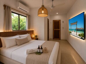 A hotel room with a bed, a window with curtains, a wall-mounted air conditioner, a hanging light fixture, a door, and a framed picture on the wall. - Hotel Holbox Centro (Isla Holbox)