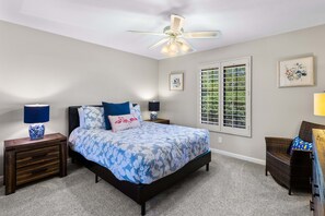 A bedroom with a bed, two bedside tables, a ceiling fan, a window with blinds, and a framed picture on the wall. - Boqueron and Beyond | Private Pool & Spa | Entertainer's Backyard | 3BR | Bermuda Dunes (Bermuda Dunes)