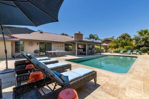 A pool area with lounge chairs and a covered patio. - Boqueron and Beyond | Private Pool & Spa | Entertainer's Backyard | 3BR | Bermuda Dunes (Bermuda Dunes)
