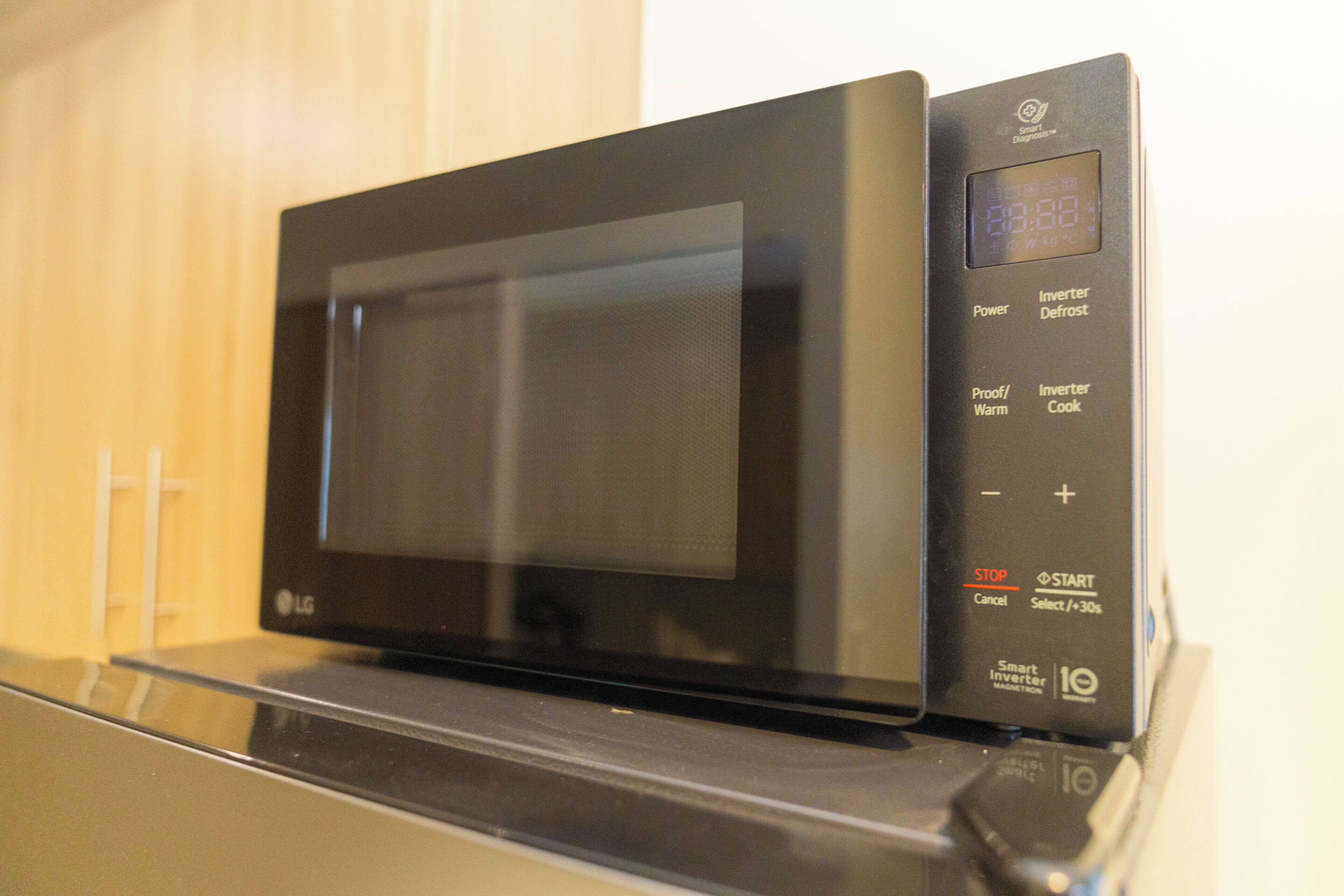 A black microwave oven with a digital display on the right side.