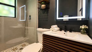A modern bathroom with a toilet, shower, and sink. - Comfortable Interior • Cozy Retreat • Outdoor Living (Miami)