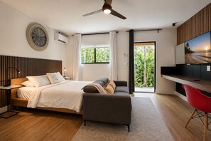 A modern bedroom with a bed, bedside table, and a red chair. - Comfortable Interior • Cozy Retreat • Outdoor Living (Miami)
