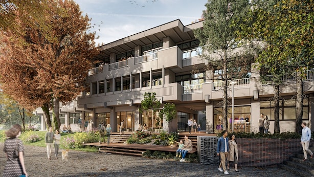 Un immeuble à plusieurs étages doté d’une architecture moderne, avec des balcons et de grandes fenêtres.