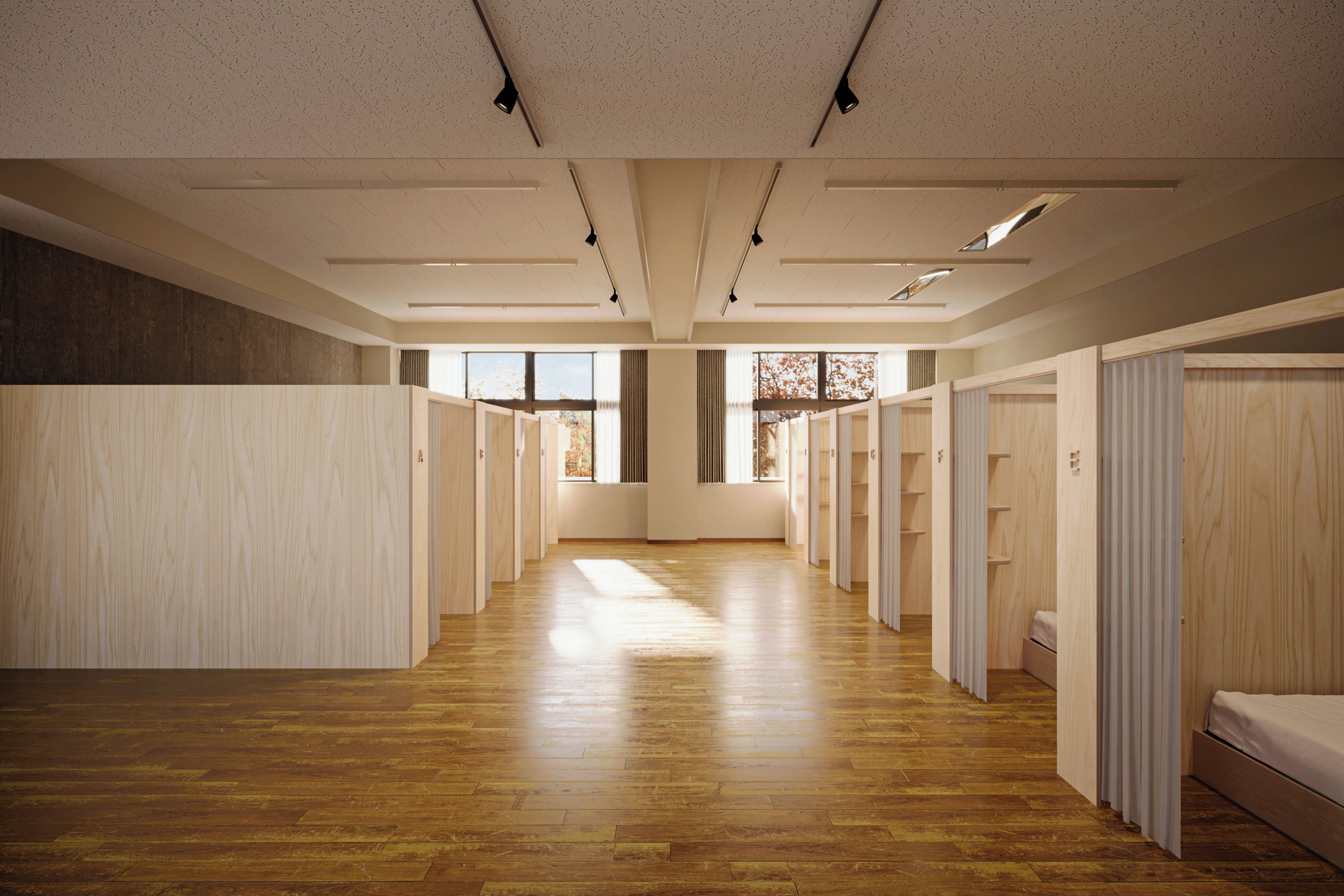 A hotel corridor with wooden flooring, multiple rooms, and a large window providing natural light.