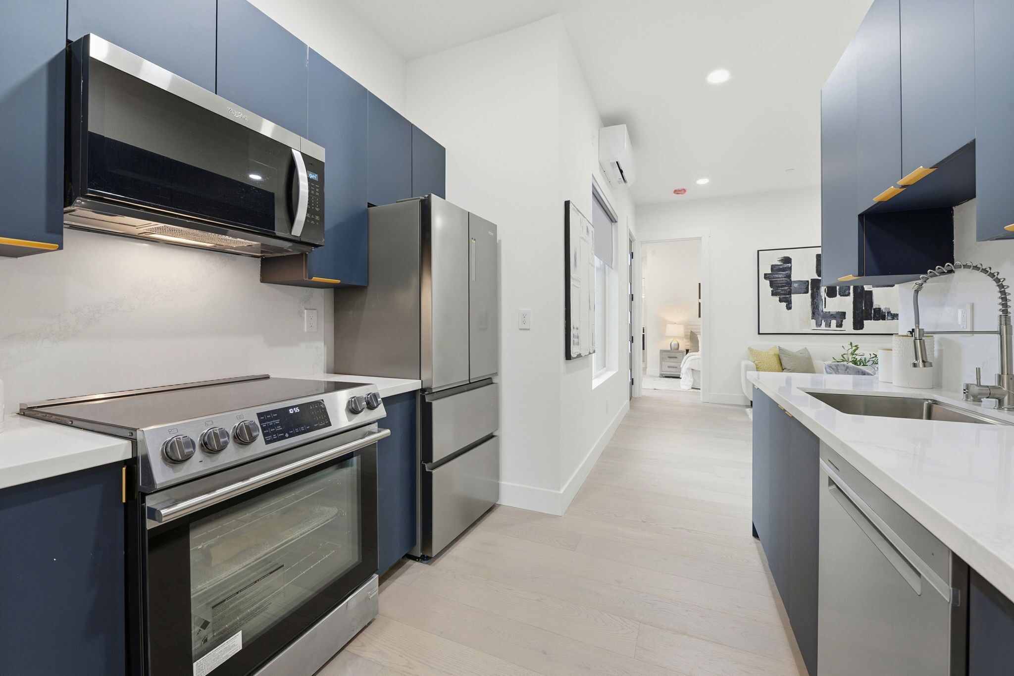 A modern kitchen with stainless steel appliances, a built-in oven, and a microwave.