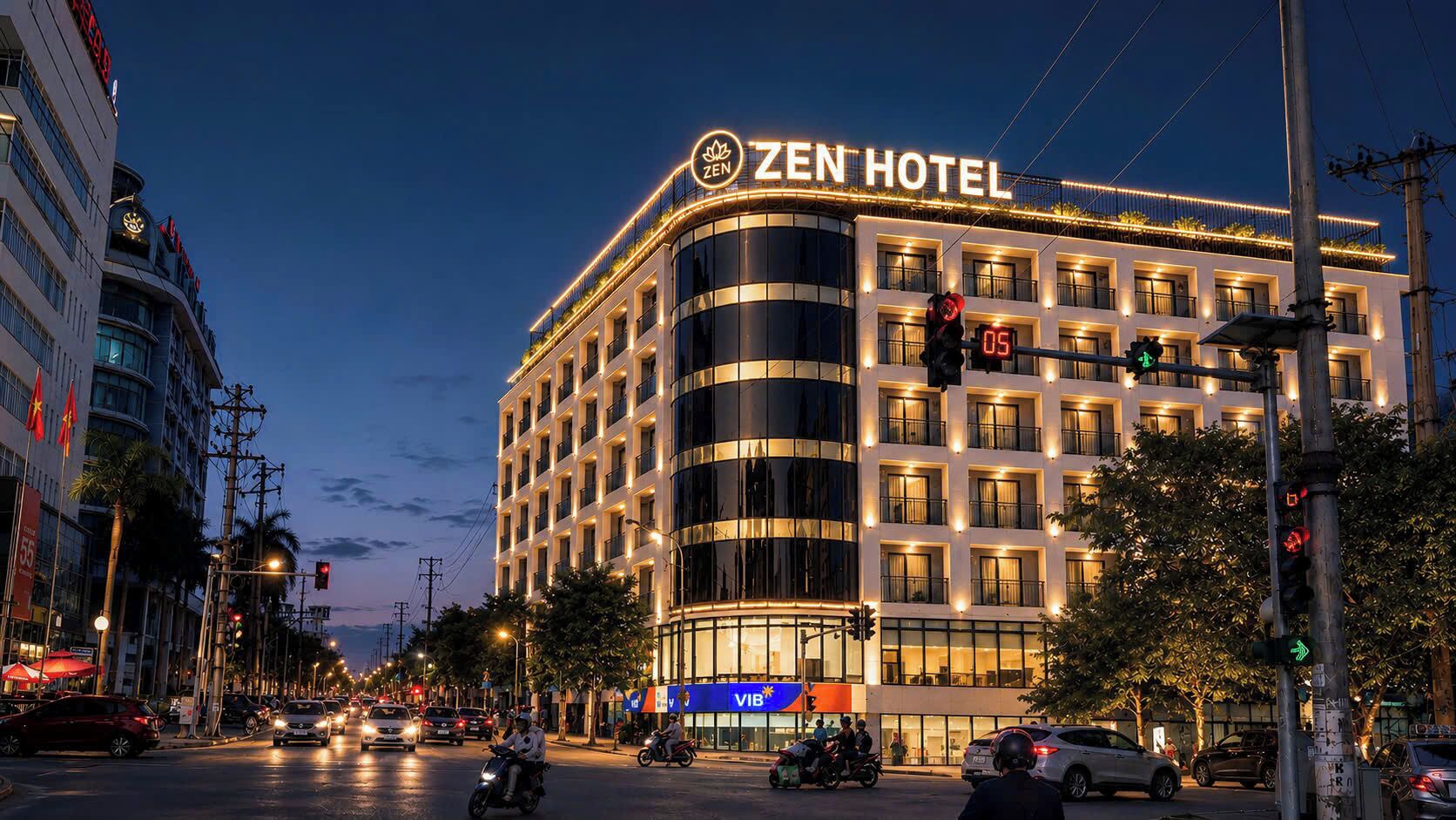 A multi-story hotel with a prominent 'ZEN HOTEL' sign, a modern architectural design, and a street view with traffic lights and vehicles.