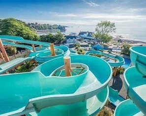 A water park with multiple water slides. - The Bay View  Sea Views, Pool, Parking & Sleeps 6 (Paignton)