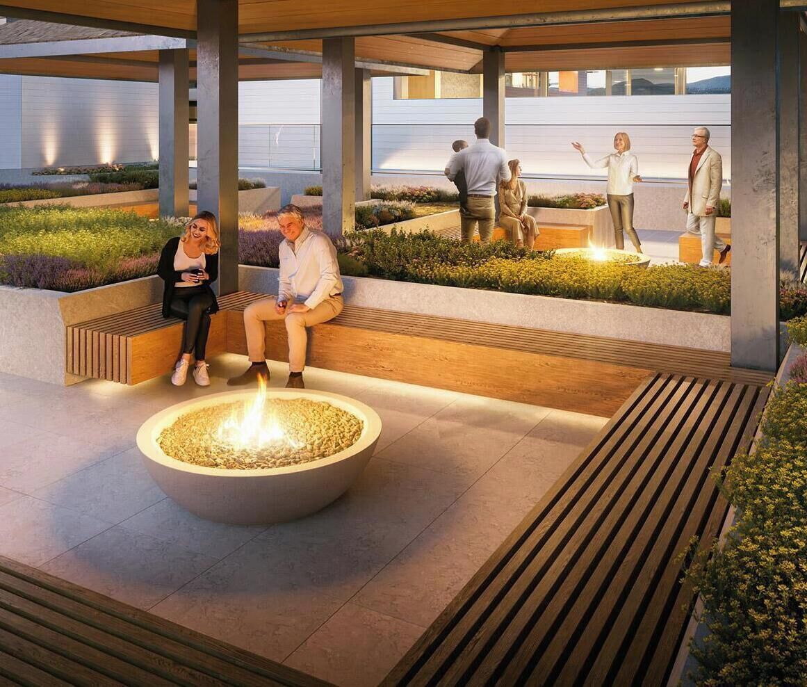 A modern outdoor seating area with a fire feature, benches, and a landscaped garden.