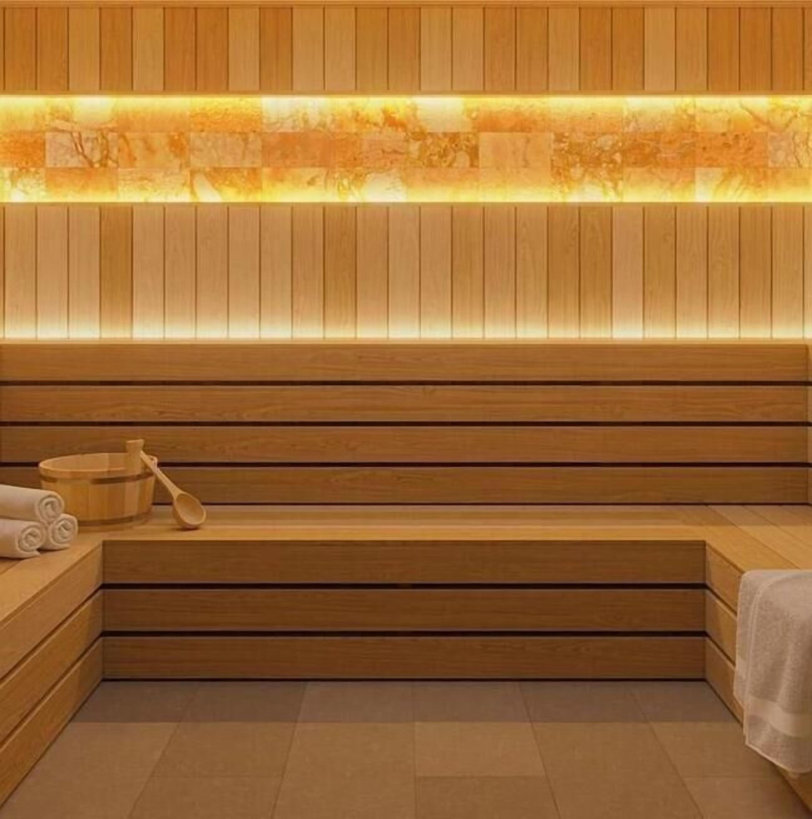 A wooden sauna with benches and a heated wall.