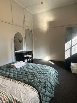 A hotel room with a bed, a desk, a chair, a mirror, and a window. - 5 Mins to Central Sydney
Lord Raglan Hotel (Alexandria)