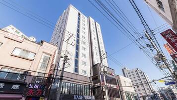 A multi-story building with a prominent sign for 'HASH HOTEL' on the ground floor.