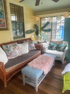 A cozy room with wicker furniture, a bench, and a window with a view. - Princess of The Lake (Caroga Lake)