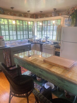 A kitchen with a central island, a refrigerator, a stove, and a sink. - Princess of The Lake (Caroga Lake)