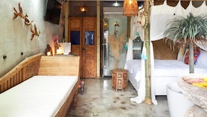 A room with a bed, a small table, a decorative plant, and a wall-mounted TV. - FAS Glass House II - Color Space BnB (Xincheng)