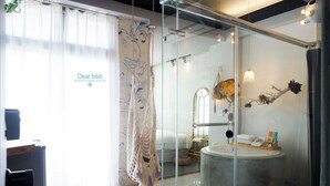 A modern bathroom with a glass partition, a bathtub, and a vanity with a mirror. - FAS Glass House II - Color Space BnB (Xincheng)