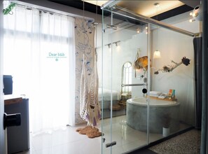 A modern bathroom with a glass partition, a bathtub, and a vanity with a mirror. - FAS Glass House II - Color Space BnB (Hualien County)