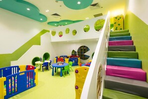 Ein Kinderspielbereich mit bunten Möbeln und einer Treppe mit farbenfrohen Stufen.