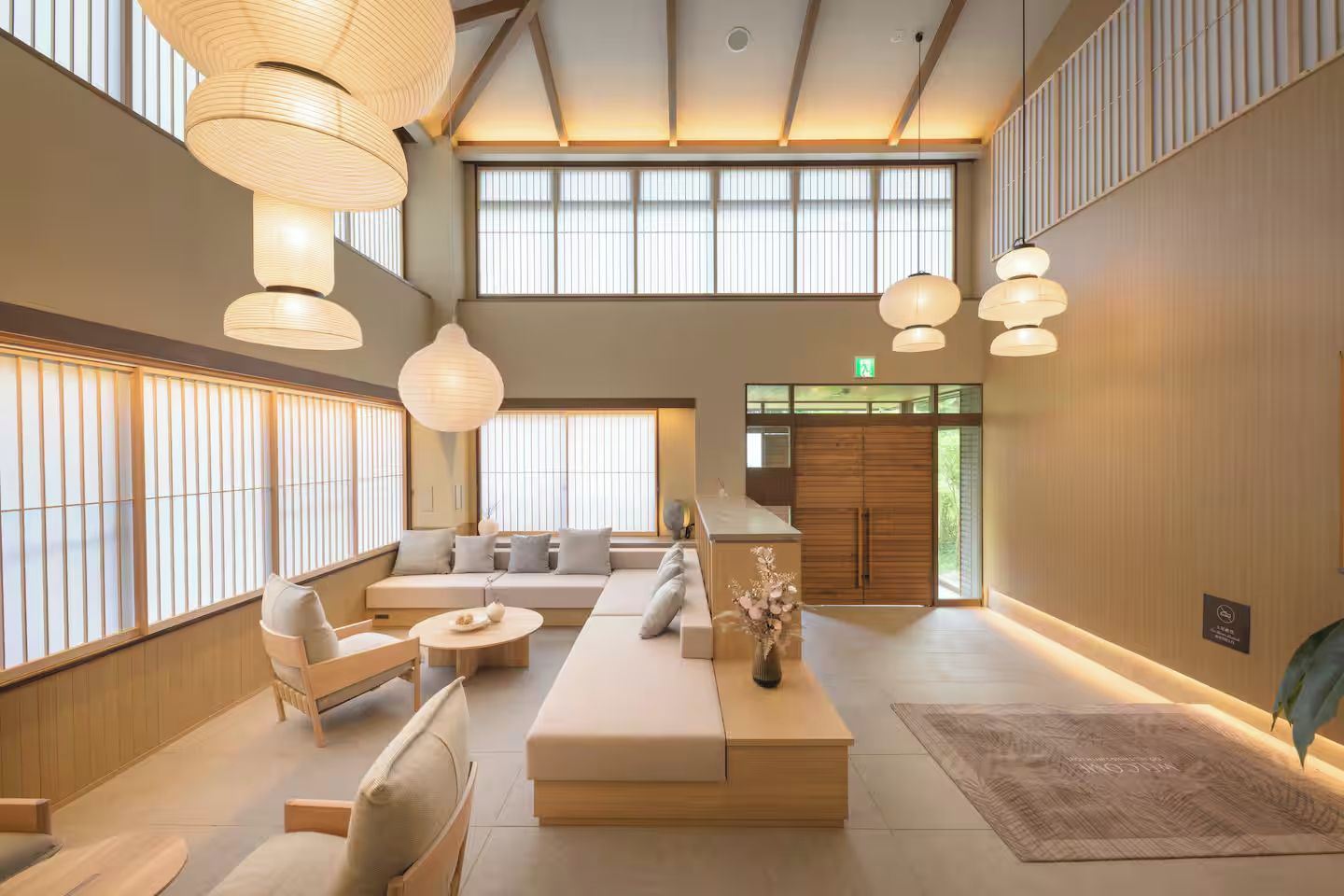 A spacious lobby with a seating area, large windows, and traditional decor.