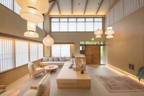 A spacious lobby with a seating area, large windows, and traditional decor.