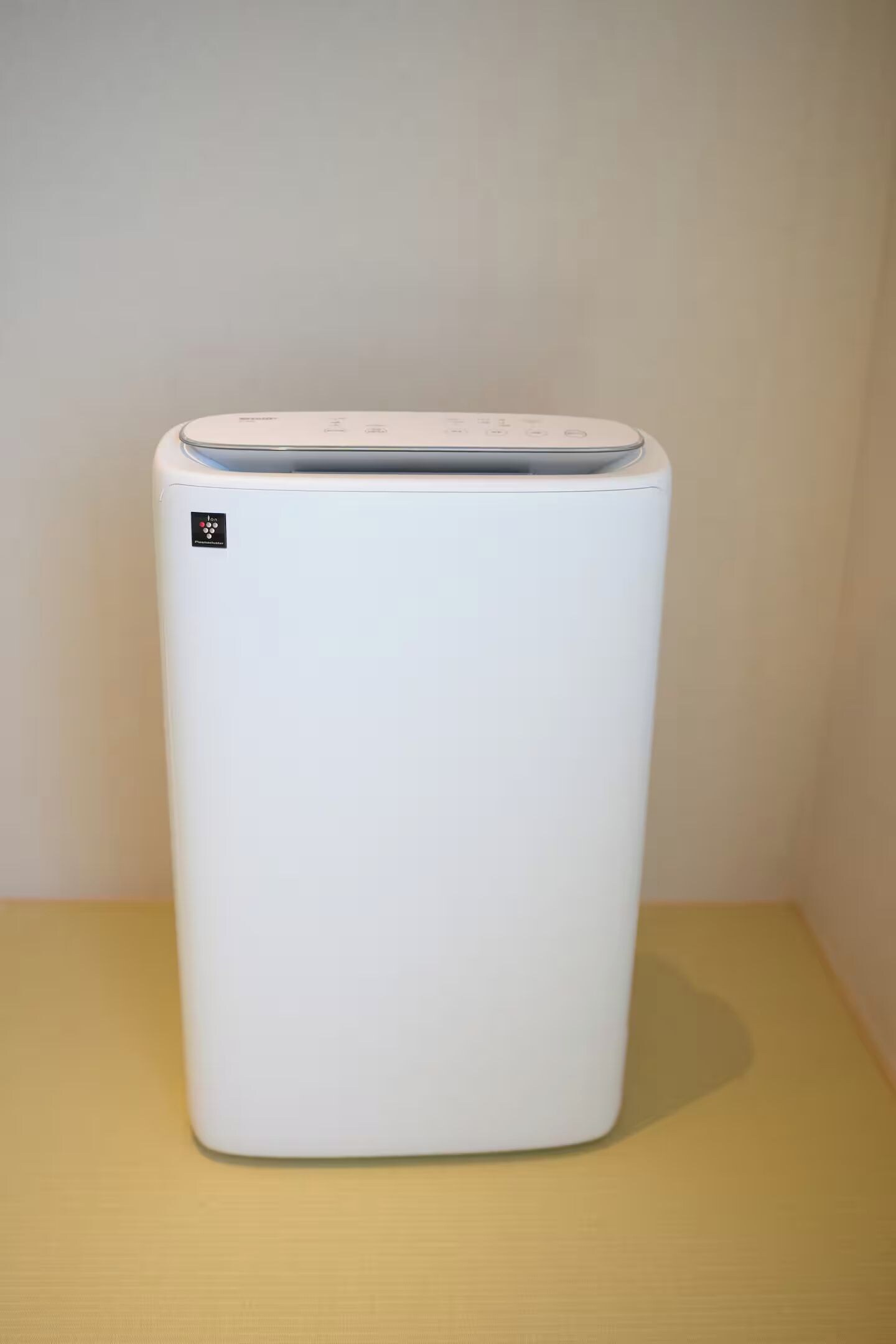 A white, standalone, modern-looking appliance on a plain surface.