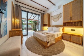 A modern bedroom with a large bed, wooden headboard, and a view of the outdoors. - Blue Wave | 3BR Escape in Prime Ubud w Pool+Garden (Ubud)